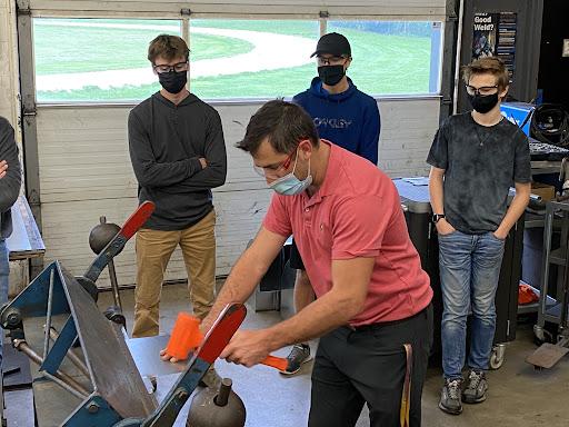 SMDCVI teacher Chris Huber demonstrating forming a sheet metal seam to the students in his Manufacturing Technology class.