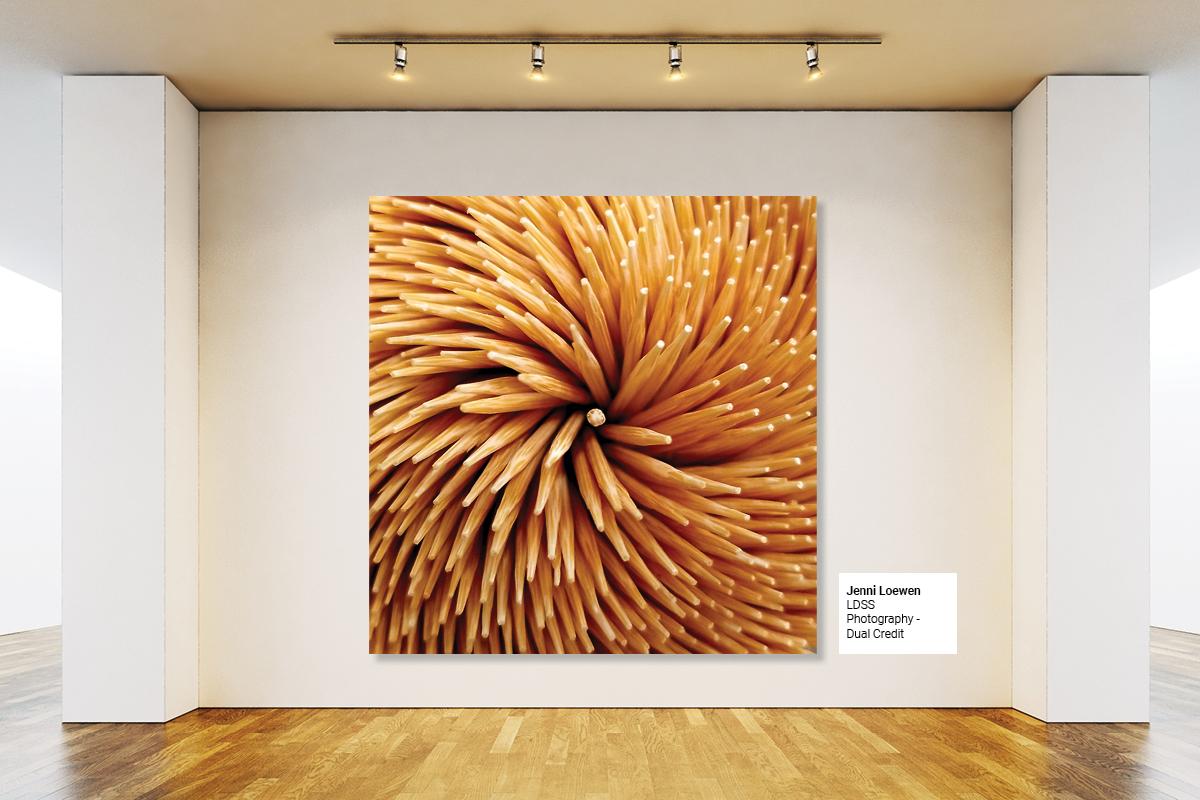 Graphic including stock background of art gallery displaying student image of toothpicks in flowerburst formation.